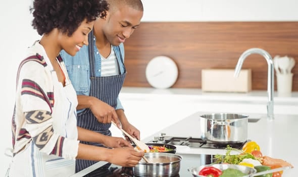 A couple cooking together A couple cooking together