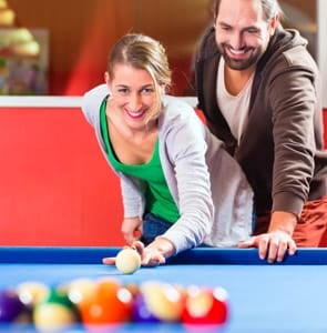 A photo of a couple playing pool