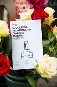 Photo of a Talkspace relationship manual in a wedding bouquet