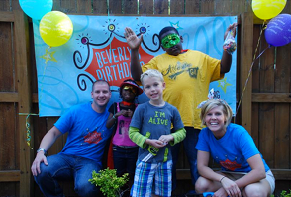 Photo of volunteers at a birthday party for homeless children