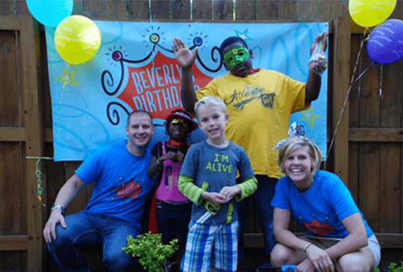 Photo of volunteers at a birthday party for homeless children