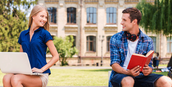 Photo of a man and woman looking at each other on a bench