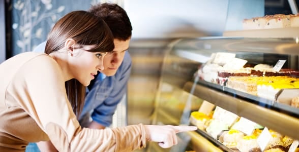 Photo of a woman and man looking at sweets
