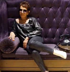 Photo of Dorrie Jacobson posing on a couch