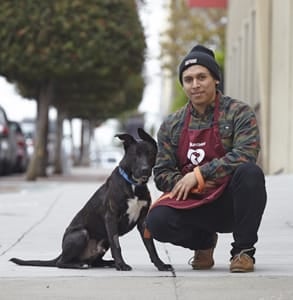 An SF SPCA volunteer with a dog
