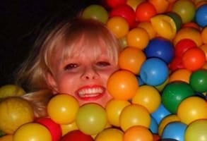 Photo of Becky in a ball pit