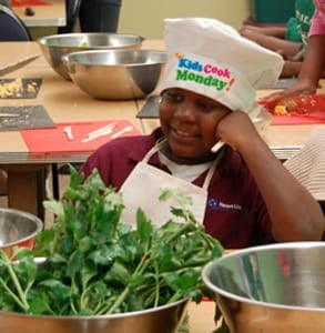 Photo of a boy taking part in the Kids Cook Monday campaign