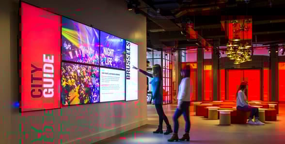 Photo of guests looking at Radisson RED's Digital Wall