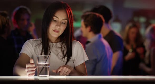 Photo of a woman alone at a bar Photo of a woman alone at a bar