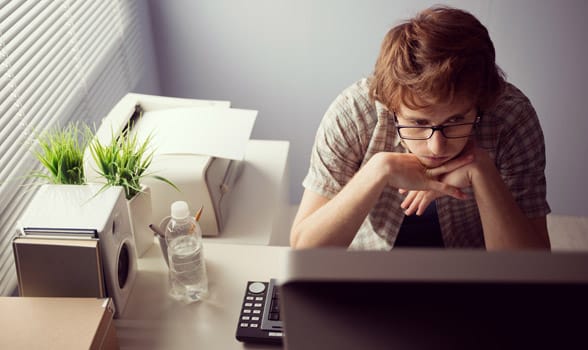 Photo of a man staring at his computer
