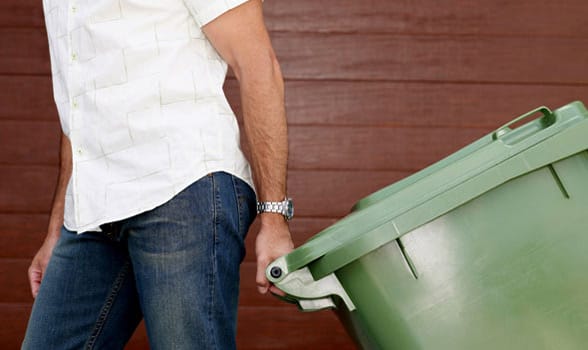 Photo of a man taking the trash out