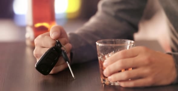 Photo of someone holding a drink and car keys