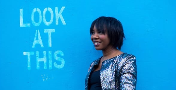 Photo of a woman in front of a blue wall