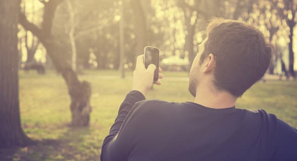 Photo of a man on his phone
