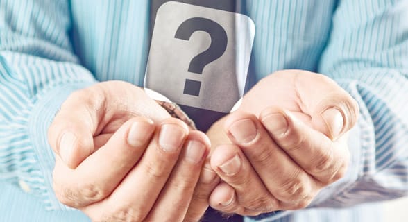Photo of a man holding a question mark