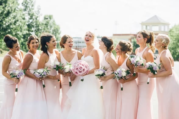 Photo of a bridal party with bouquets 