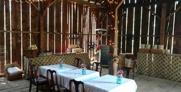 Photo of tables in a barn at the Hummingbird Room