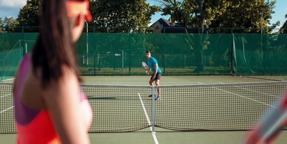 Photo of a couple playing tennis