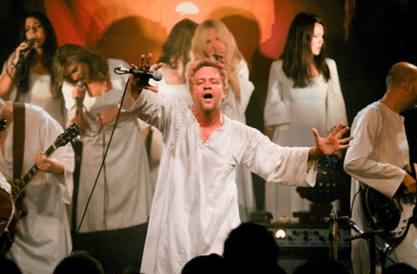 Photo of Tim DeLaughter on stage with The Polyphonic Spree