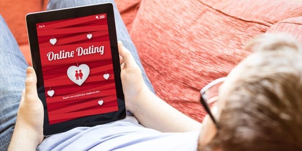 Photo of a man looking at a dating site Photo of a man looking at a dating site