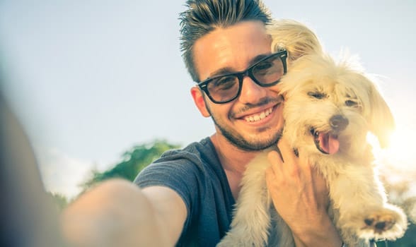 Photo of a man taking a selfie with a dog Photo of a man taking a selfie with a dog