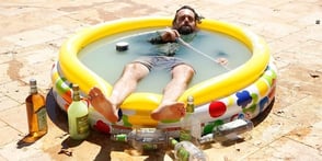 Photo of a man in a kiddie pool Photo of a man in a kiddie pool