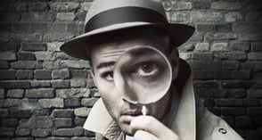 Photo of a man looking through a magnifying glass Photo of a man looking through a magnifying glass
