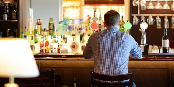 Photo of a man alone at a bar
