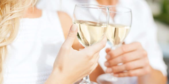Photo of a couple clinking wine glasses