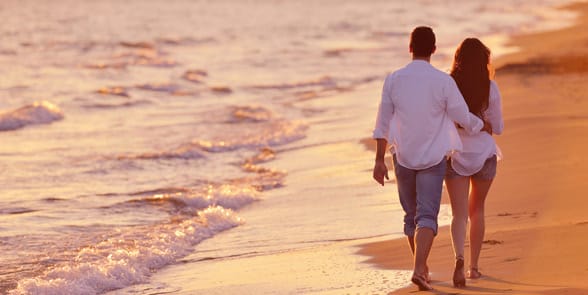 Photo of a couple on a beach Photo of a couple on a beach