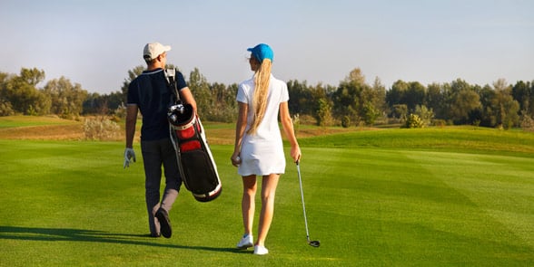 Photo of a couple playing golf