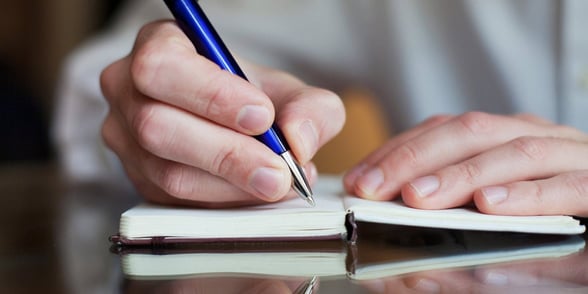 Photo of a man writing a letter