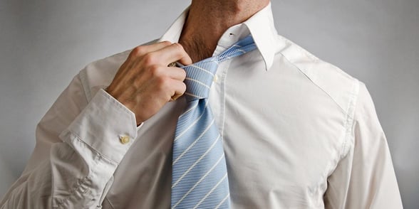 Photo of a man pulling on his collar