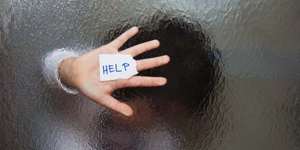 Photo of someone with help written on their hand