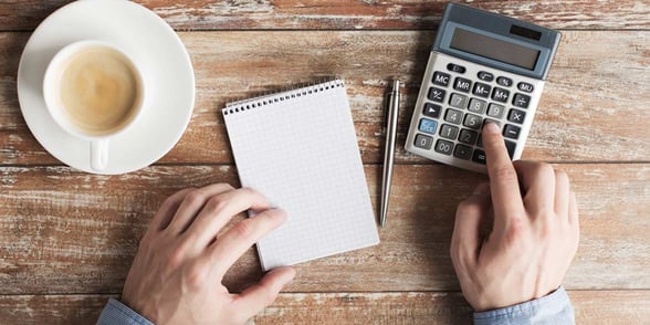 Photo of a man using a calculator