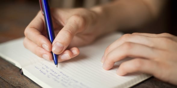 Photo of a woman writing