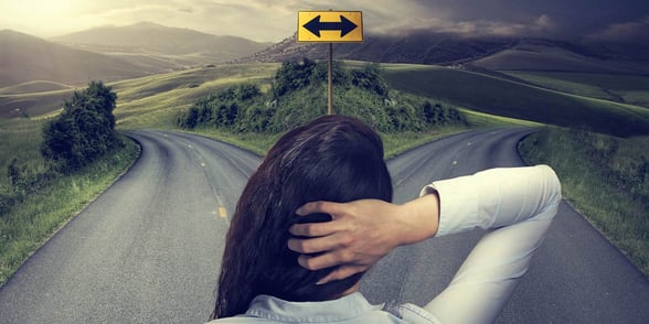 Photo of a woman looking at a crossroads