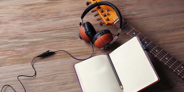 Photo of headphones and a guitar