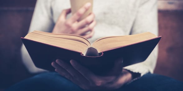 Photo of a man reading a book