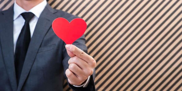 Photo of a man holding a heart