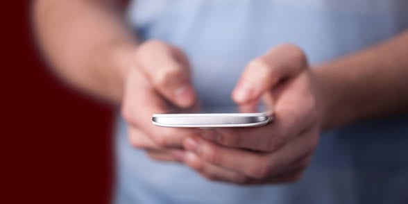 Photo of a man texting