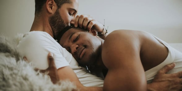 Photo of two men in bed Photo of two men in bed