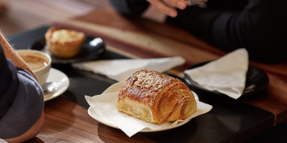 Photo of coffee and a pastry Photo of coffee and a pastry