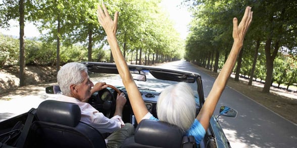 Photo of two mature people in a convertible