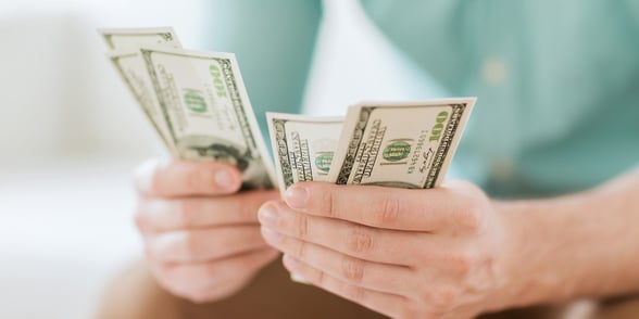 Photo of a man counting money Photo of a man counting money