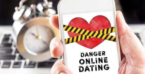 Photo of a phone with a danger sign
