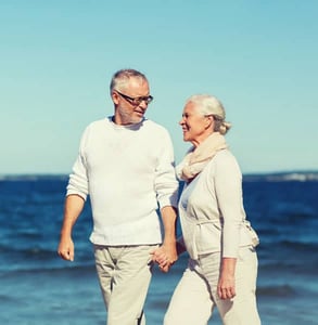 Photo of a senior couple walking on the beach Photo of a senior couple walking on the beach
