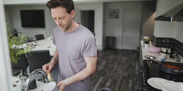 Photo of a man doing the dishes