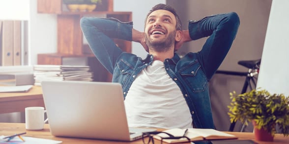 Photo of a man relaxing with a laptop