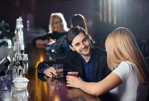 Photo of a couple flirting at a bar